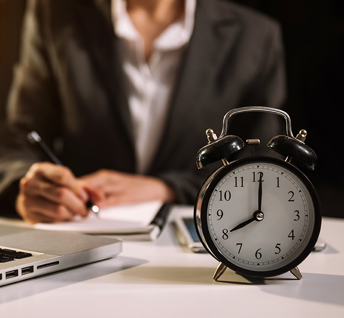 Alarm clock on the desk. Business working in modern office build